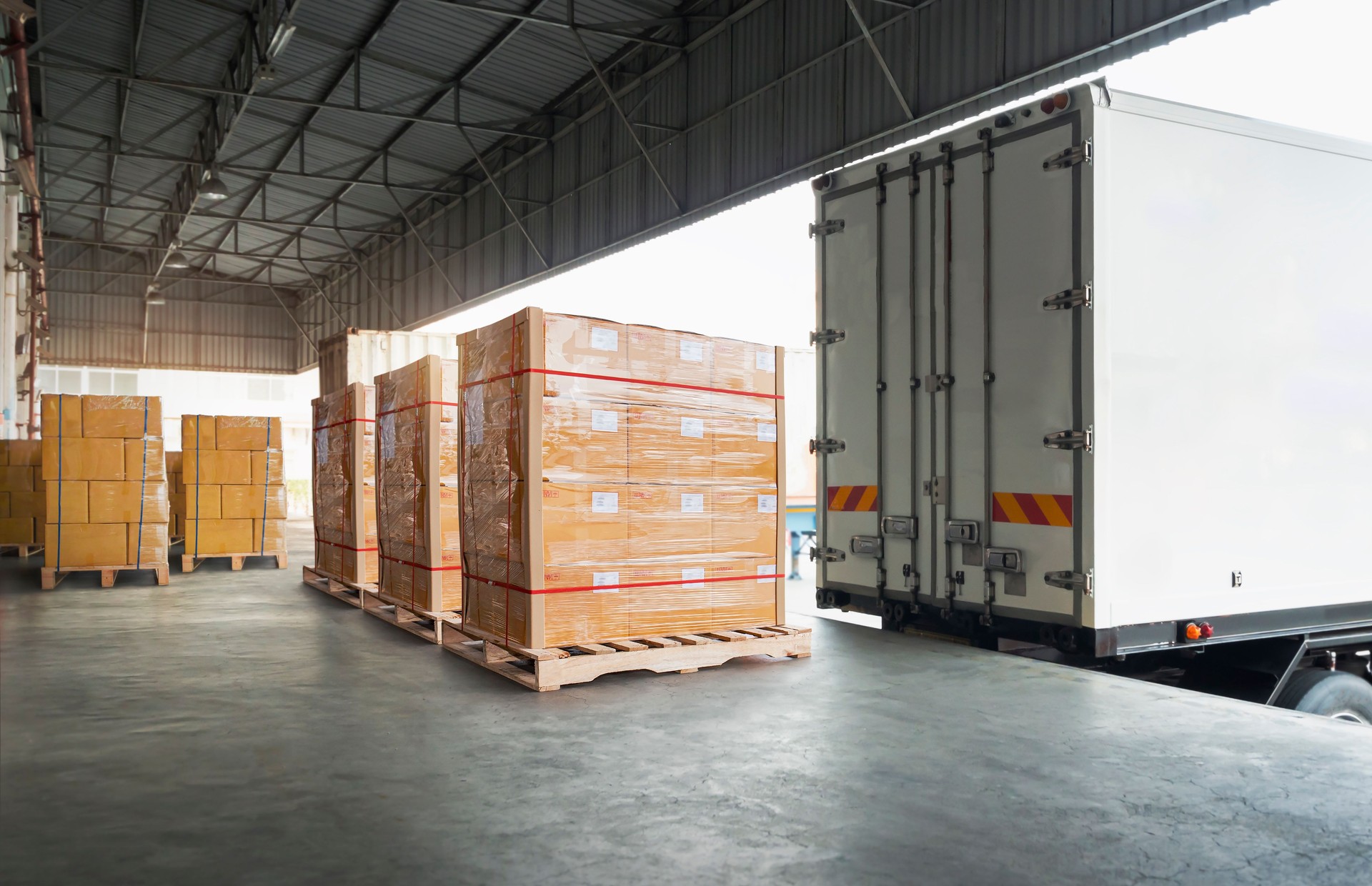 Packaging Boxes Wrapped Plastic Stacked on Pallets Loading into Cargo Container. Shipping Trucks. Supply Chain Shipment. Distribution Supplies Warehouse. Freight Truck Transport Warehouse Logistics.